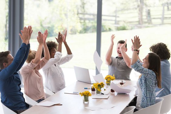 a team in office clapping