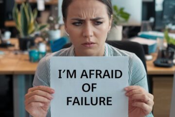 a corporate woman holding a white board that says “I’m afraid of failure"